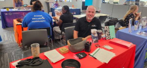 Mortgage broker answering common VA home loan questions while attending the Mid-Michigan VA Benefits Fair, including credit scores, down payments, condo financing, and VA loan eligibility.